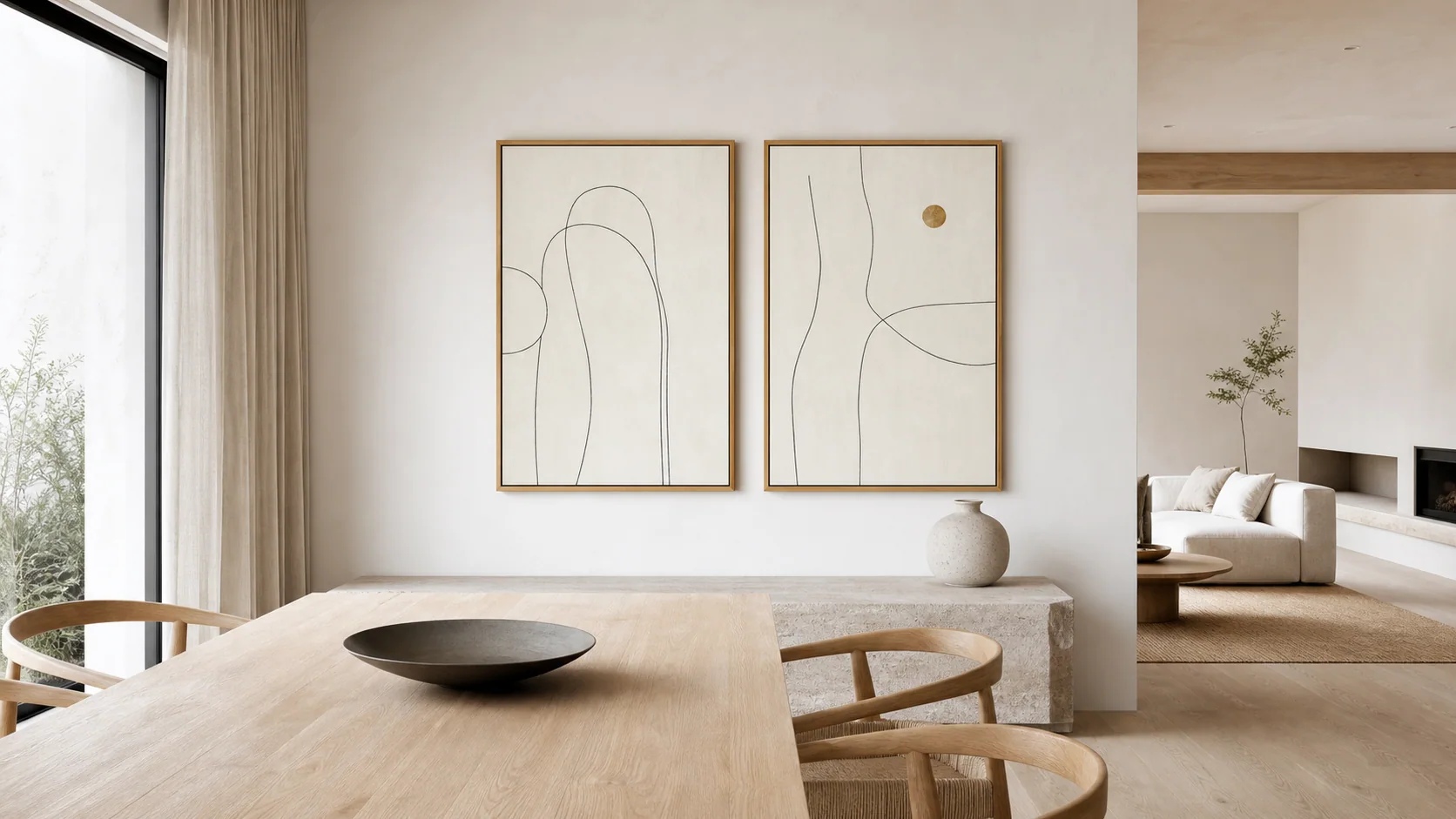 Light-filled dining room with two framed minimalist prints